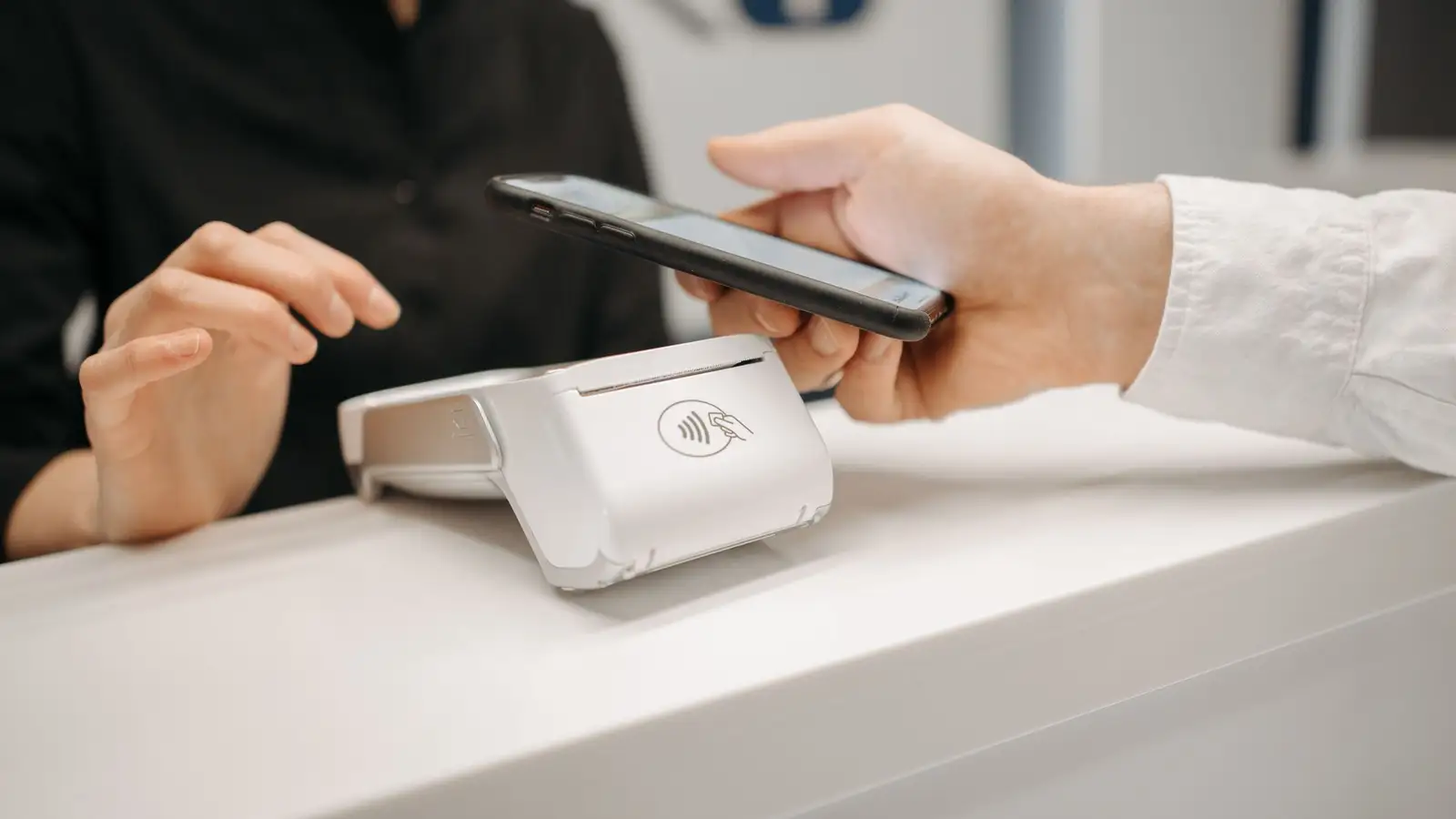 A customer paying contactless with a smartphone